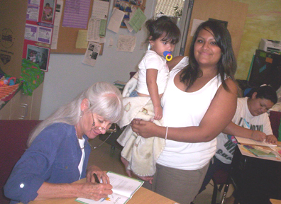 This is a photograph of me signing a book for Angela's daughter.